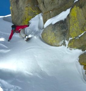 Sierra snowboarder down narrow chute
