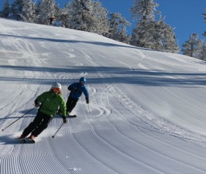 Diamond Peak skiers on groomer