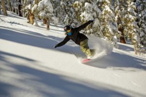 Heavenly snowboarder in the trees