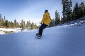 A snowboarder heads down the hill today, the season opener for Northstar California.