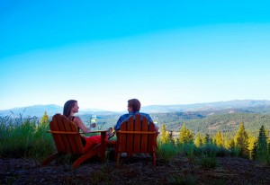 A couple enjoys one of the many beautiful summer sunsets at The Ritz-Carlton, Lake Tahoe, which is located mid-mountain at Northstar California ski resort. 